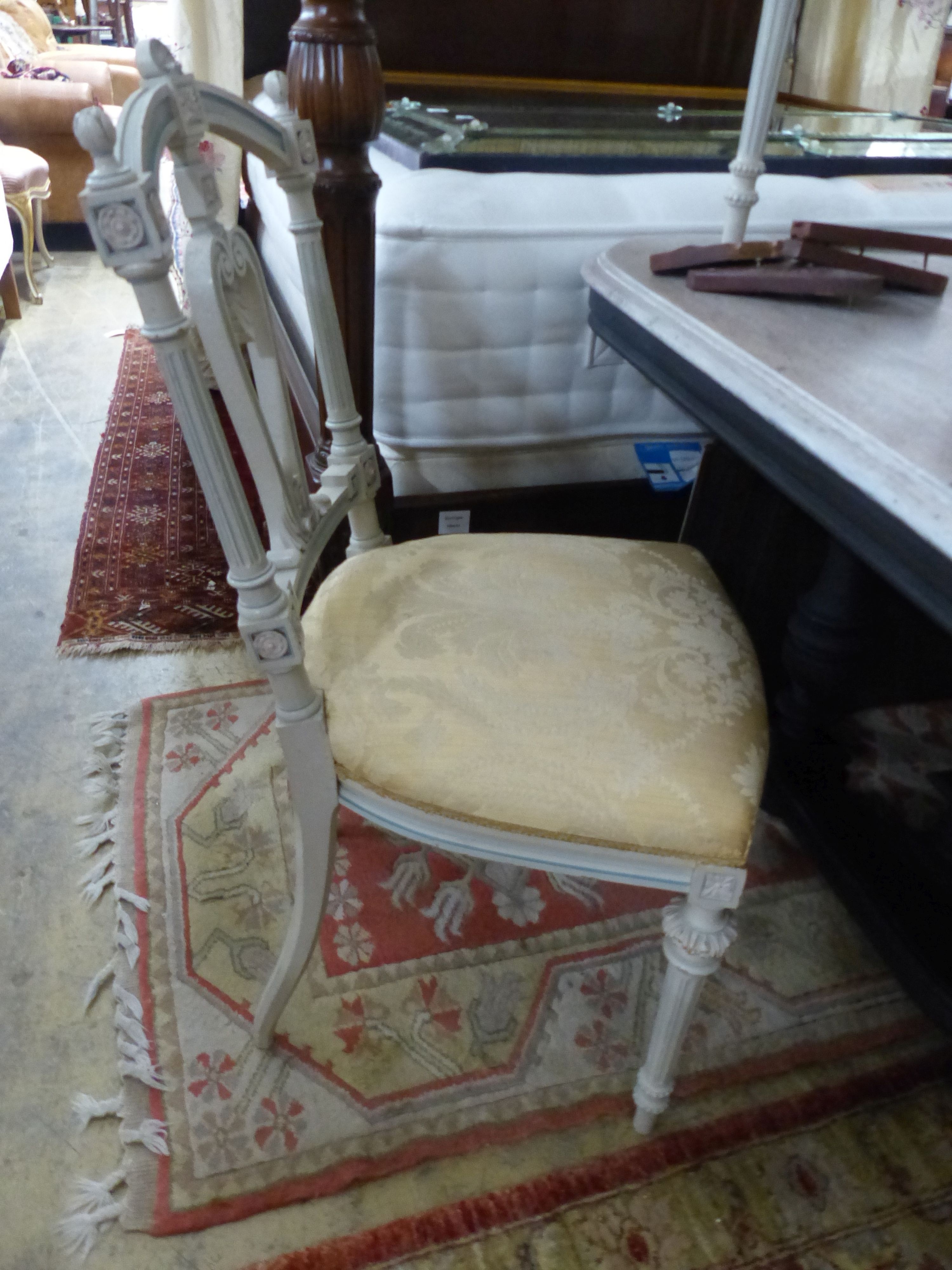 A set of four French light green painted salon chairs